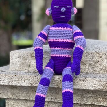 knitted figure of a robot in purple color